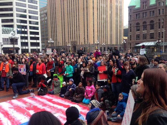 Black Lives Matter protesters around chalk drawing of U.S.A. flag for Day of Resistance in front of Hennepin County Government Center, Minneapolis, December 13, 2014