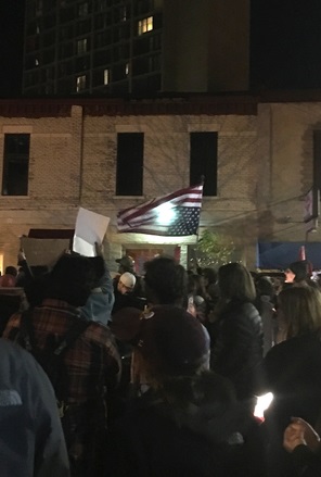 Protesters with upside down U.S.A. flag