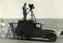 Man with movie camera on top of sound truck on location at Providence, Rhode Island, circa 1930