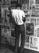 Man putting up 1966 Cassis Festival posters