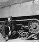 Army photographs, Tank Destroyer Unit: Unidentified soldier by tank treads (2)