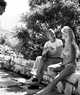 Jerome Hill with Brigitte Bardot, at Cassis, sitting on wall