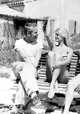Jerome Hill with Brigitte Bardot, at Cassis, sitting on bench